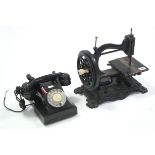 A Vintage hand sewing machine, uncased; & a G.P.O. black Bakelite telephone.