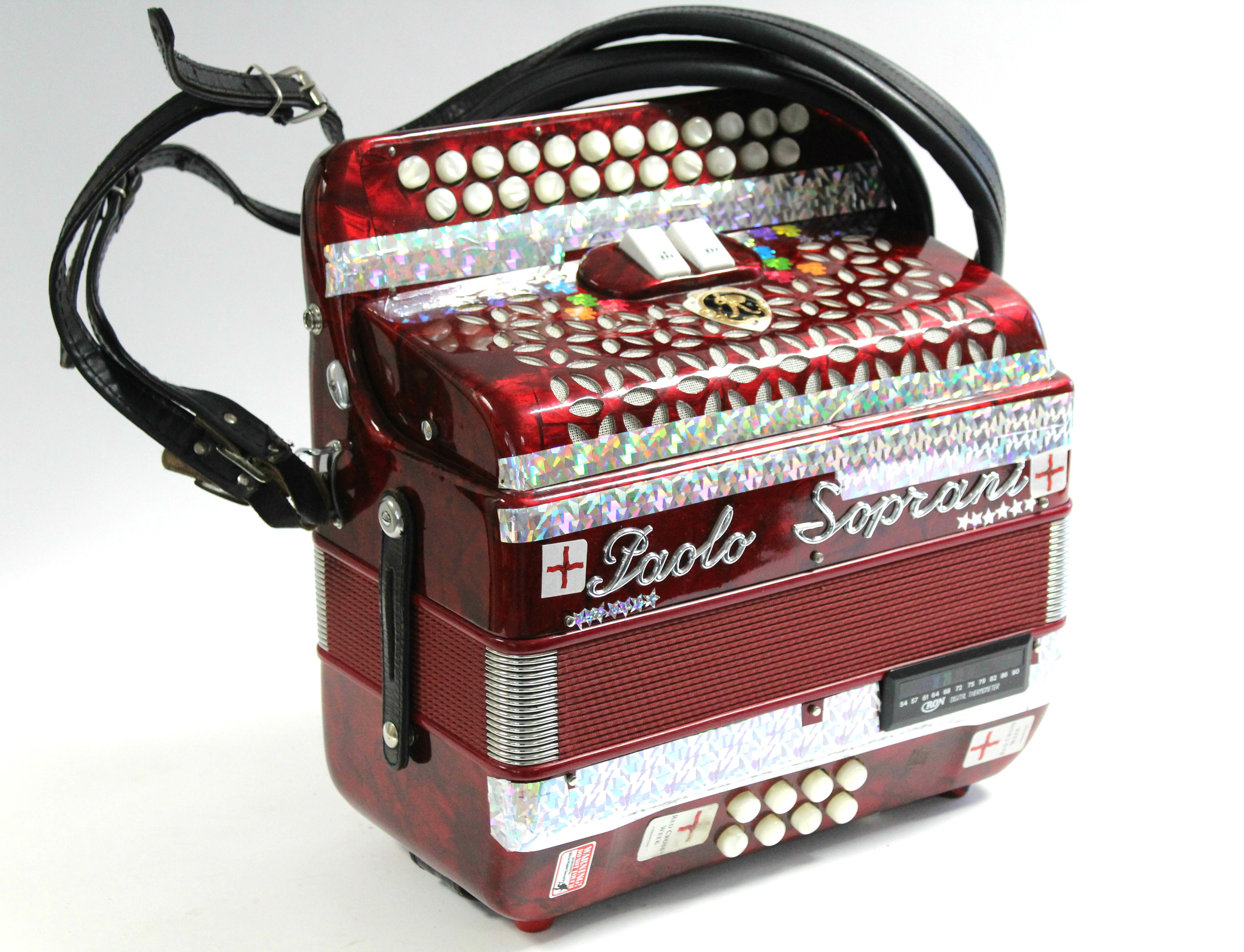 A Paolo Soprani piano accordion in red polished case, & with fibre-covered carrying case.