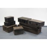 Eight various japanned-metal travelling trunks.