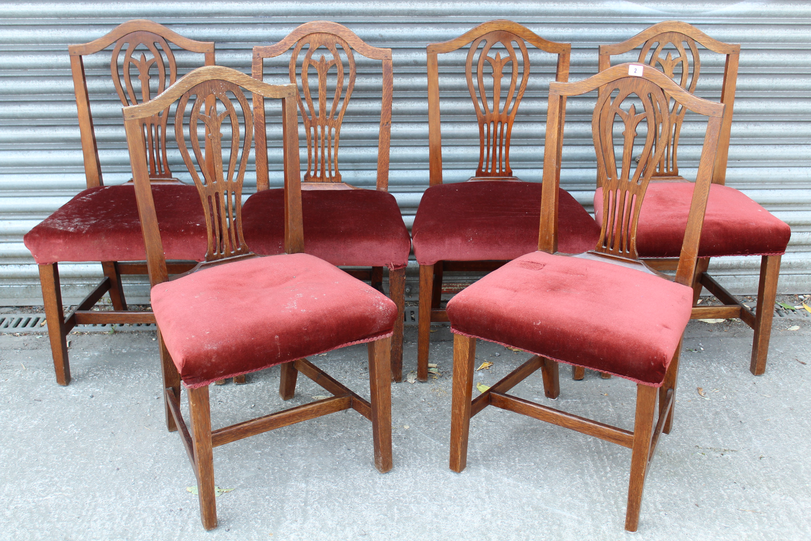 A set of six Georgian oak dining chairs with pierced & shaped splat backs, padded seats & on