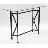 A black-finish wrought-metal conservatory table with tempered glass rectangular top, 48” wide.