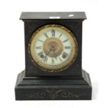 A Victorian mantel clock with black roman numerals to the white enamel dial, with striking