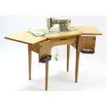 A Necchi “Julia 534” electric sewing machine in mahogany-finish case, & on square tapered legs, 59”