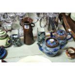 Two Royal Doulton stoneware globular tea pots; a pair of Royal Doulton floral decorated vases; a set