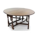 An early 18th century-style mahogany oval gate-leg dining table fitted single drawer to one end, 63"