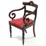 A Georgian carved mahogany elbow chair with padded seat, & on turned tapered legs, slight faults.