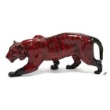 A Royal Doulton flambé ornament in the form of a tiger in stalking pose, 14” long x 6” high.
