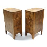 A pair of light oak three-drawer chests of narrow proportions, 12” wide x 30” high; & a light oak