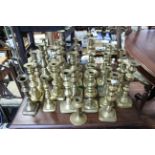 Approximately twenty various brass candlesticks; a bronzed dish, etc.