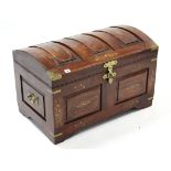 An eastern-style brass-inlaid & brass-mounted teak domed-top storage trunk with fitted interior