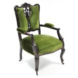 An Edwardian carved mahogany frame armchair, upholstered green velour, & on short cabriole legs with