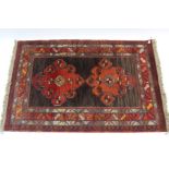 A Persian rug of rust & ivory ground with repeating geometric design to centre within a multiple