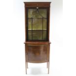 A 19th century inlaid-mahogany china display cabinet, the upper part fitted two shelves enclosed