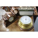 A brass-cased aneroid wall barometer with white enamel dial & mounted on oak plaque, 7” diameter;