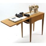 A Singer electrically operated sewing machine in teak cabinet, on square tapered legs, w.o. 24½”