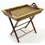 A woven-cane two-handled butler’s tray on folding wooden stand, 30” wide.