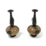 A pair of Royal Doulton stoneware vases of globular form, tall tapered necks, & on round pedestal