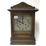 An early 20th century mantel clock with silvered dial, striking movement, & in walnut case, 17¾”
