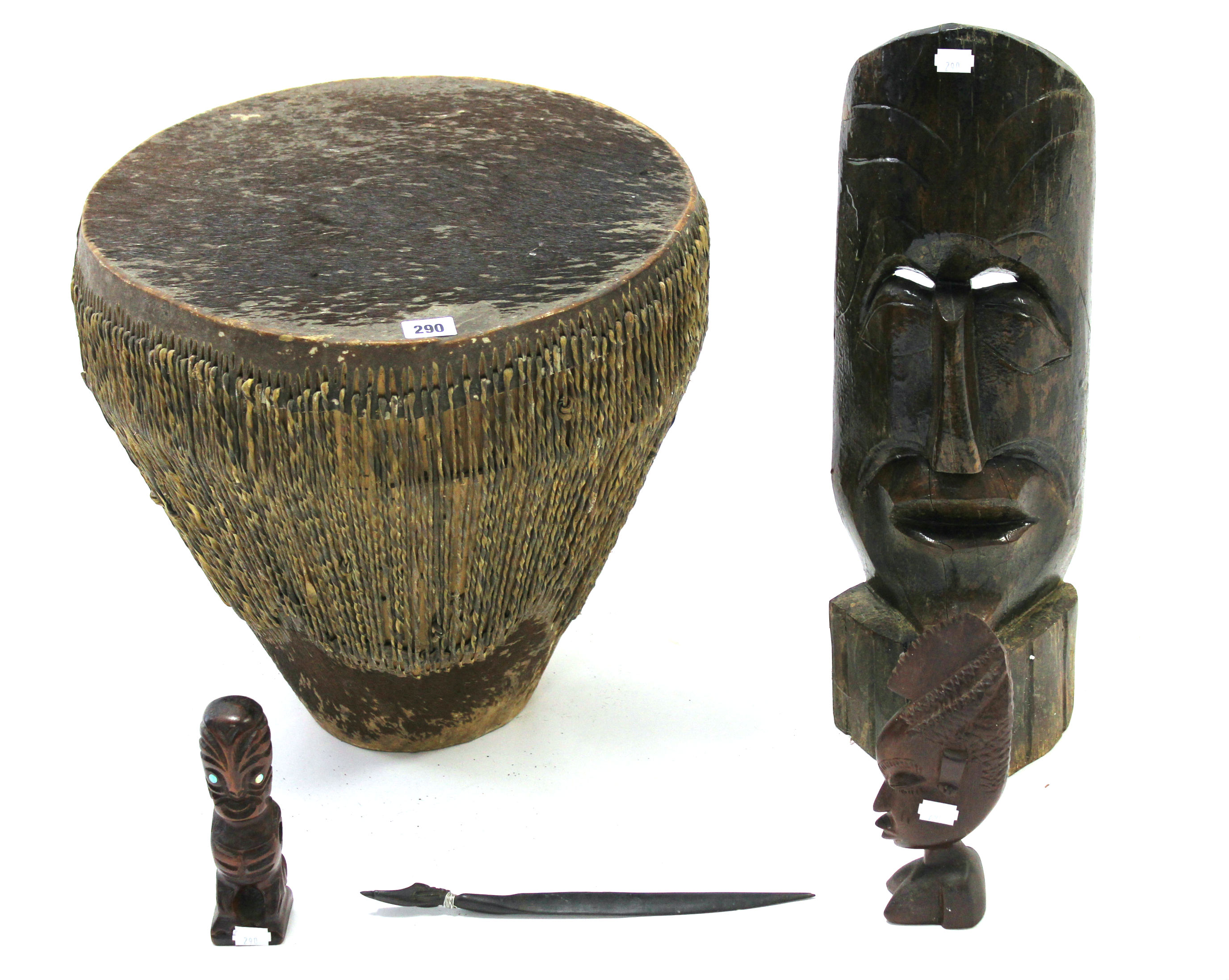 An African animal-hide covered drum, 15 ½” high; & four African carved treen ornaments.