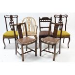 A pair of Edwardian mahogany dining chairs with pierced & shaped splat backs, padded seats, & on