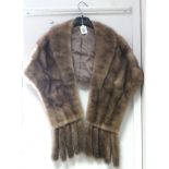 A rabbit fur stole; & another fur stole.