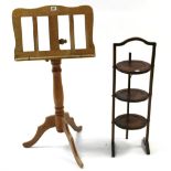 An oak folding cake stand of three circular tiers; & a beech sheet-music stand on turned centre