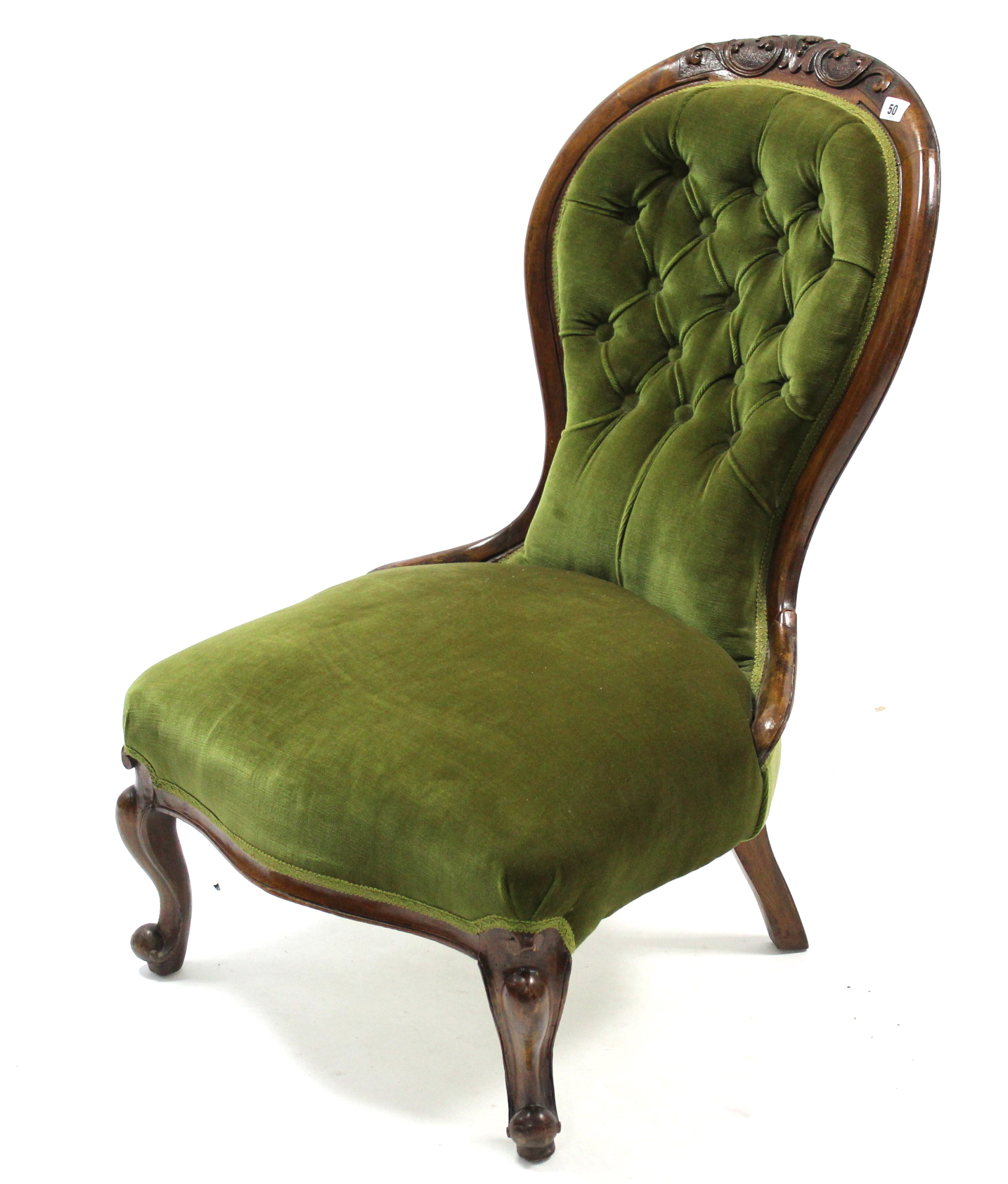 A Victorian carved walnut frame nursing chair, with buttoned back & sprung seat upholstered green