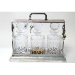 A Mappin & Webb silver plated tantalus (with key) fitted three cut-glass square decanters with