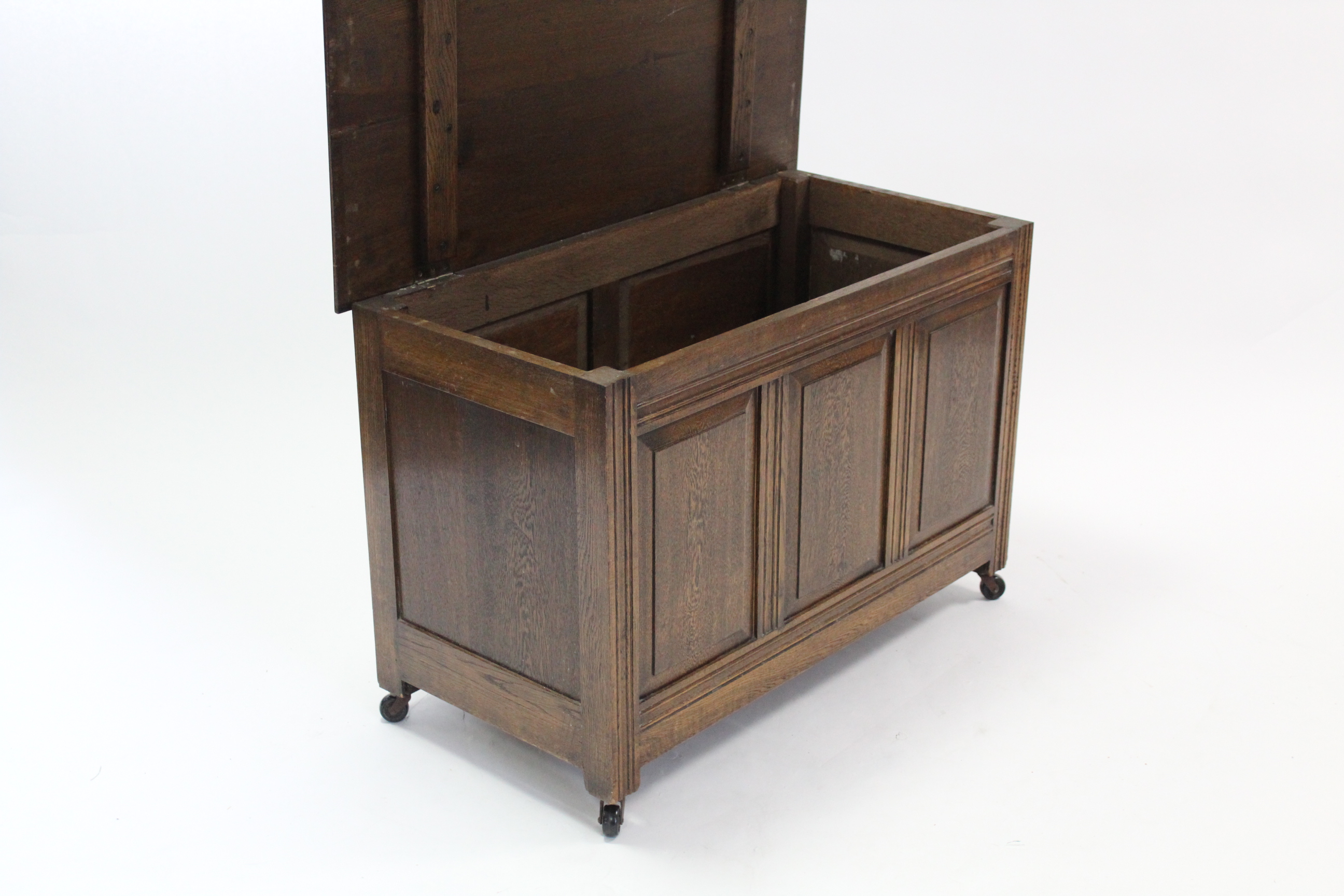 An oak coffer with hinged lift-lid, & with panelled front & sides, 37” long. - Image 2 of 3