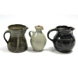 A St Ives studio pottery 4½" bulbous jug of speckled blue over chocolate brown glaze with waved line