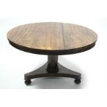 A George IV rosewood centre table, the circular tilt-top on octagonal centre column & triform base