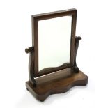 A Victorian mahogany swing toilet mirror, with rectangular plate on scroll supports & serpentine