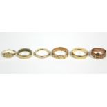 A 9ct. gold engraved belt buckle ring; a 9ct. engraved signet ring; two ditto engraved bands; a