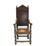 A 17th century-style carved oak Wainscot chair with marquetry decoration to the shaped back,