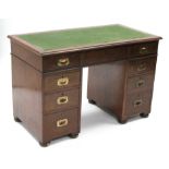 A 19th century mahogany campaign-style pedestal desk, the rectangular top inset green baize & with