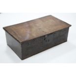 A late 17th century oak Bible box with hinged lid & naïve carved scroll decoration to the front; 26”