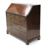 A George III inlaid mahogany bureau, the sloping fall-front enclosing a fitted interior, with