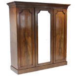 A 19th century figured mahogany wardrobe, with moulded cornice, fitted three sliding trays above