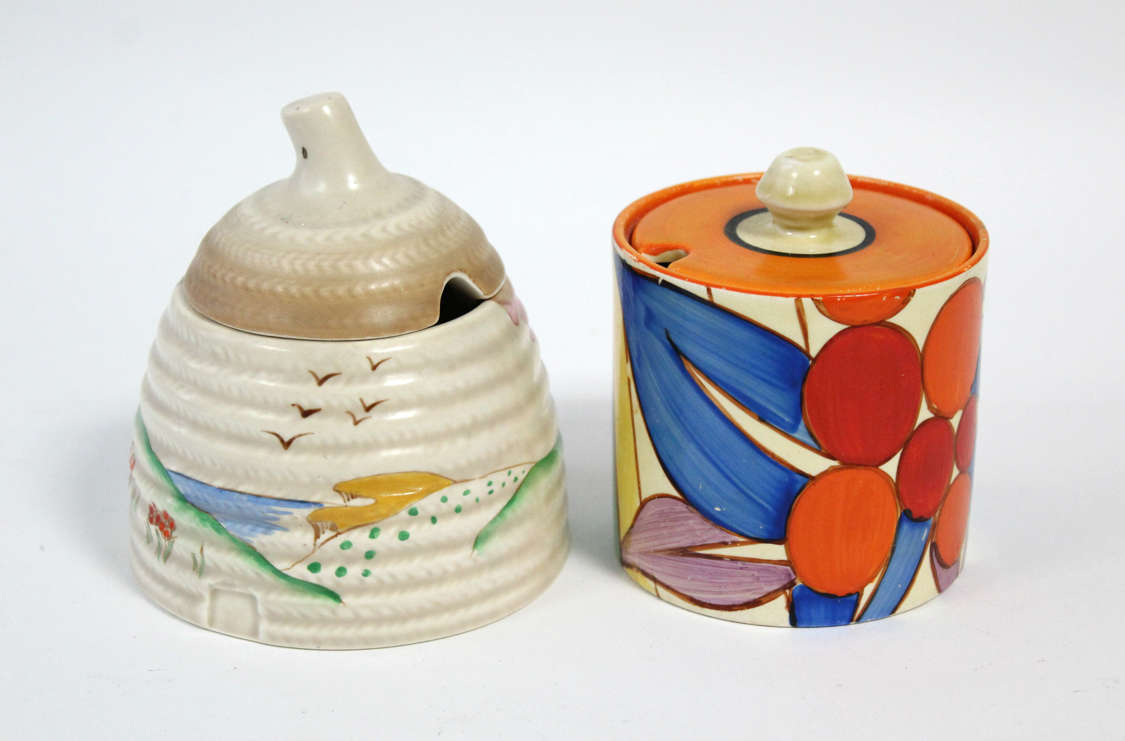 A CLARICE CLIFF “BERRIES” PATTERN PRESERVE POT, circa 1930-2, of cylindrical shape, with flat cover,