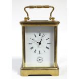 A large brass carriage clock by Matthew Norman, the white enamel dial with black roman numerals,