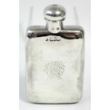An early 20th century silver pocket spirit flask with hinged ball cap & engraved monogram, 5¼" high;