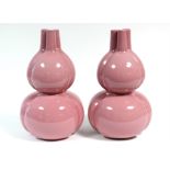 A pair of Chinese pink-ground porcelain double-gourd shaped vases of trefoil section, with three