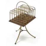 An Edwardian brass & mahogany letter/magazine rack with seven divisions labelled with days of the