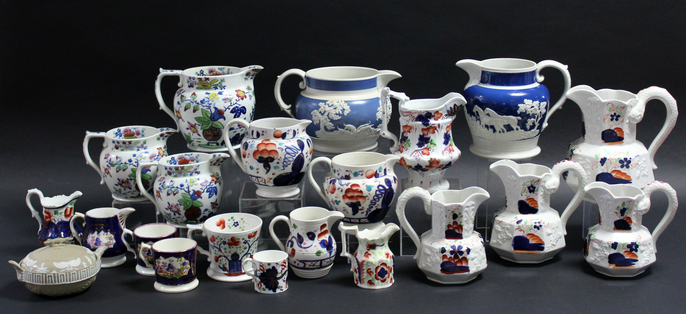 Two sets of three Victorian Staffordshire pottery floral decorated graduated jugs; twelve various