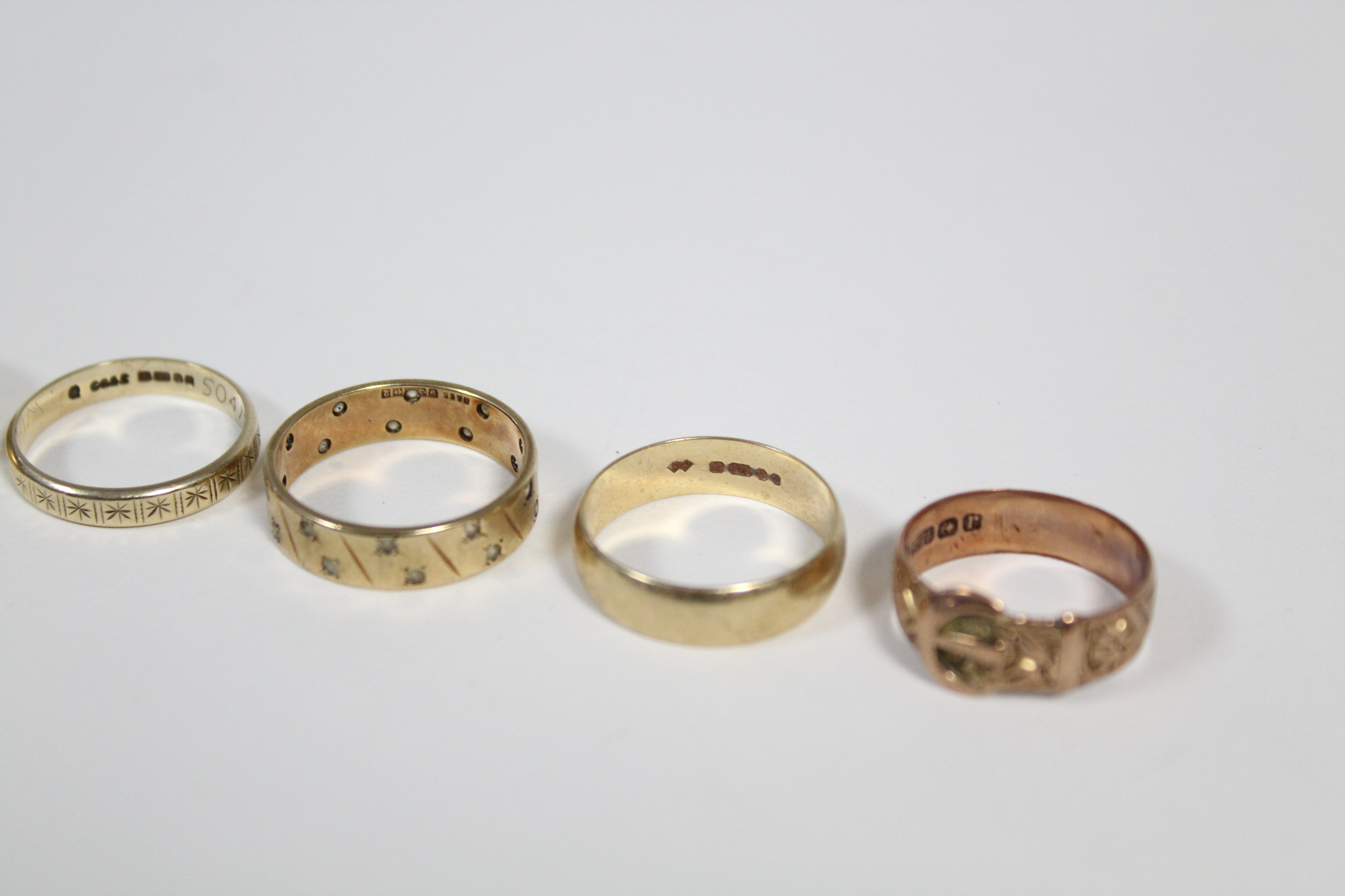 A 9ct. gold engraved belt buckle ring; a 9ct. engraved signet ring; two ditto engraved bands; a - Image 2 of 3