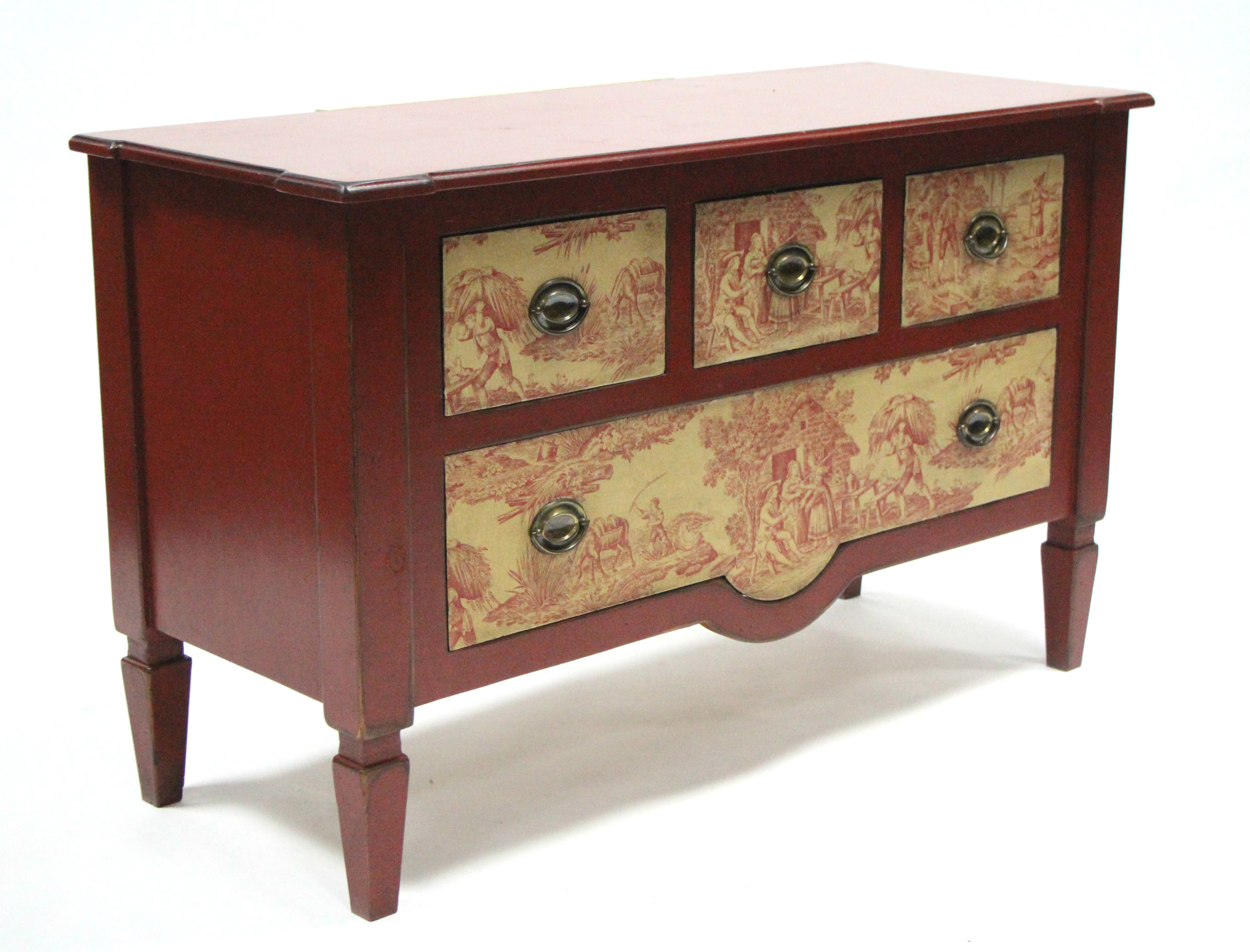 A modern red-painted chest with shaped rectangular top above three short & one long drawers with