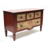 A modern red-painted chest with shaped rectangular top above three short & one long drawers with