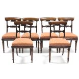 A set of five William IV rosewood bow-back dining chairs with carved centre rails, padded seats