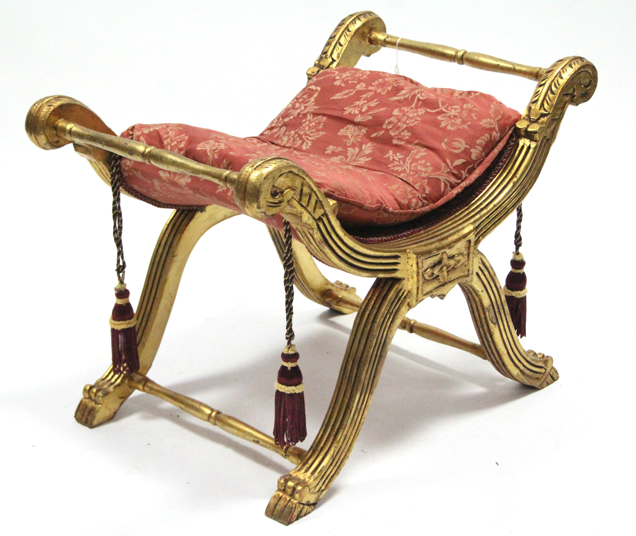 A regency-style giltwood stool, the carved & reeded ‘X’ frame joined by turned stretchers, & on