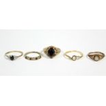 An 18ct. gold cross-over ring set small diamond; three 9ct. gold gem-set rings; & a gilt-metal dress